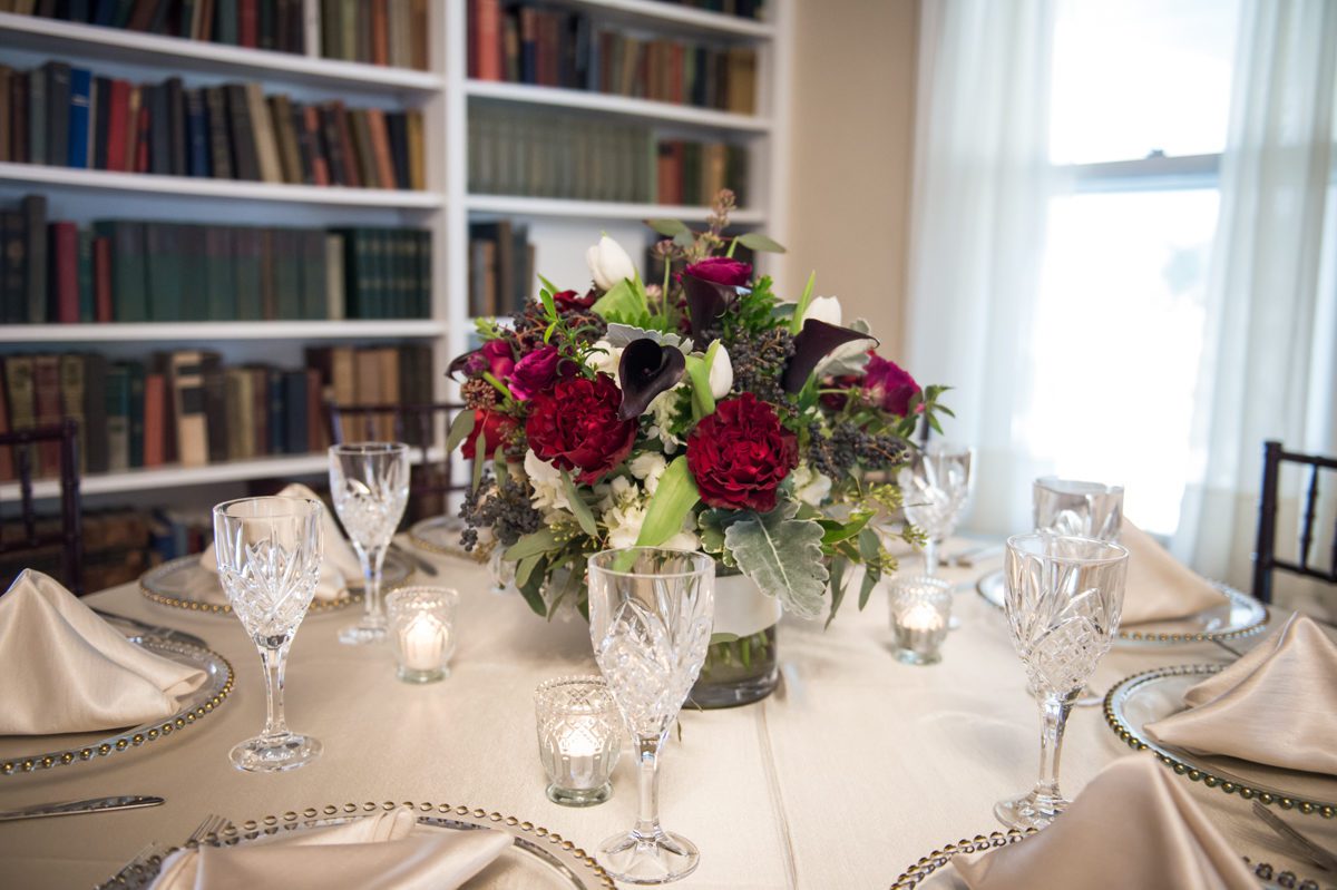 Weddings at Tarrywile White linen and Red Roses with clear plates