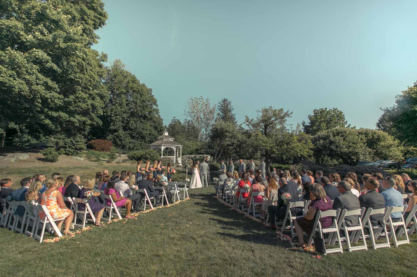 Outdoor Summer Ceremony summer-ceremony-guests-seated-on-lawn-gazebo-in-background