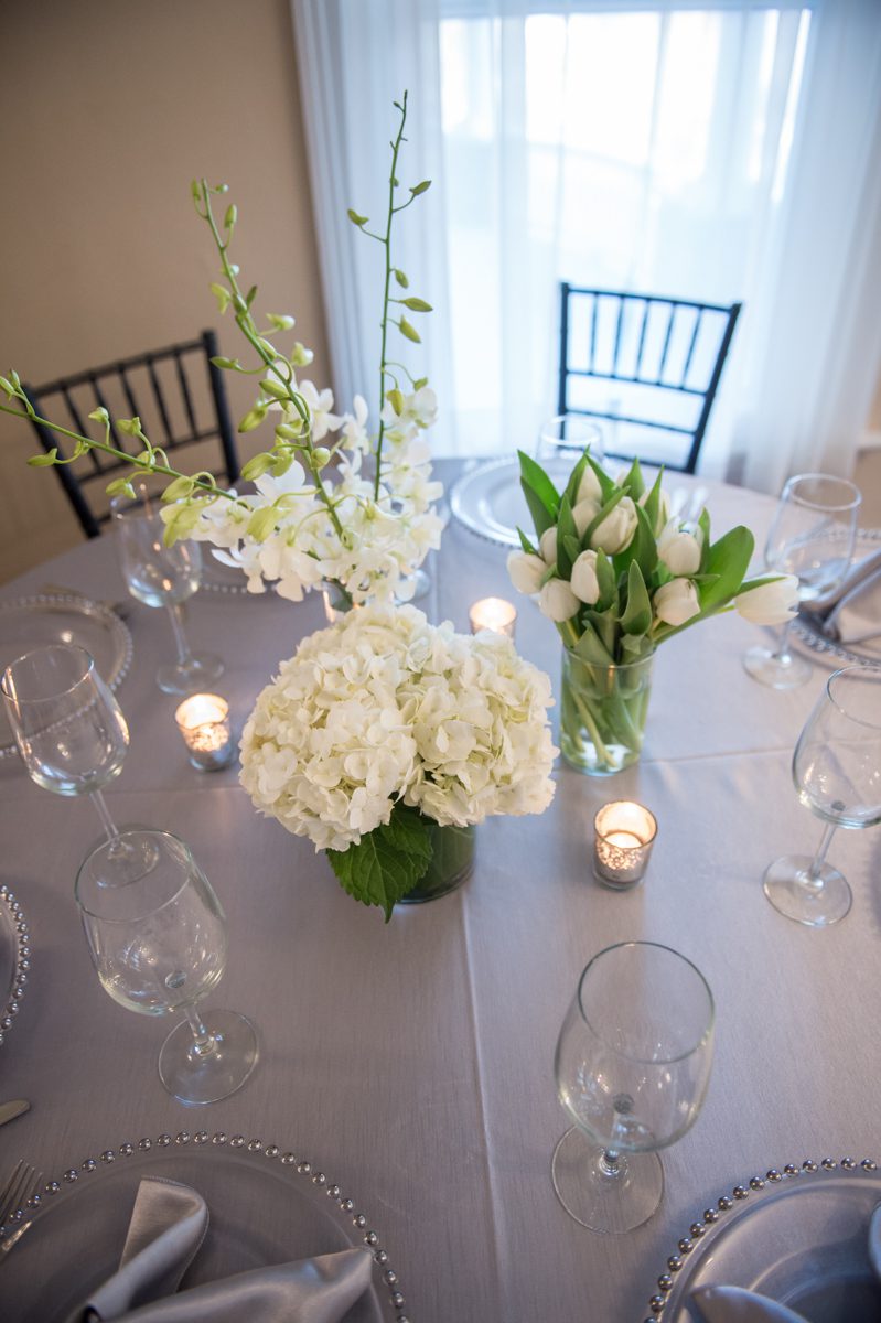 Weddings at Tarrywile Silver and Spring White with silver filigree votive make a simple table setting look elegant.