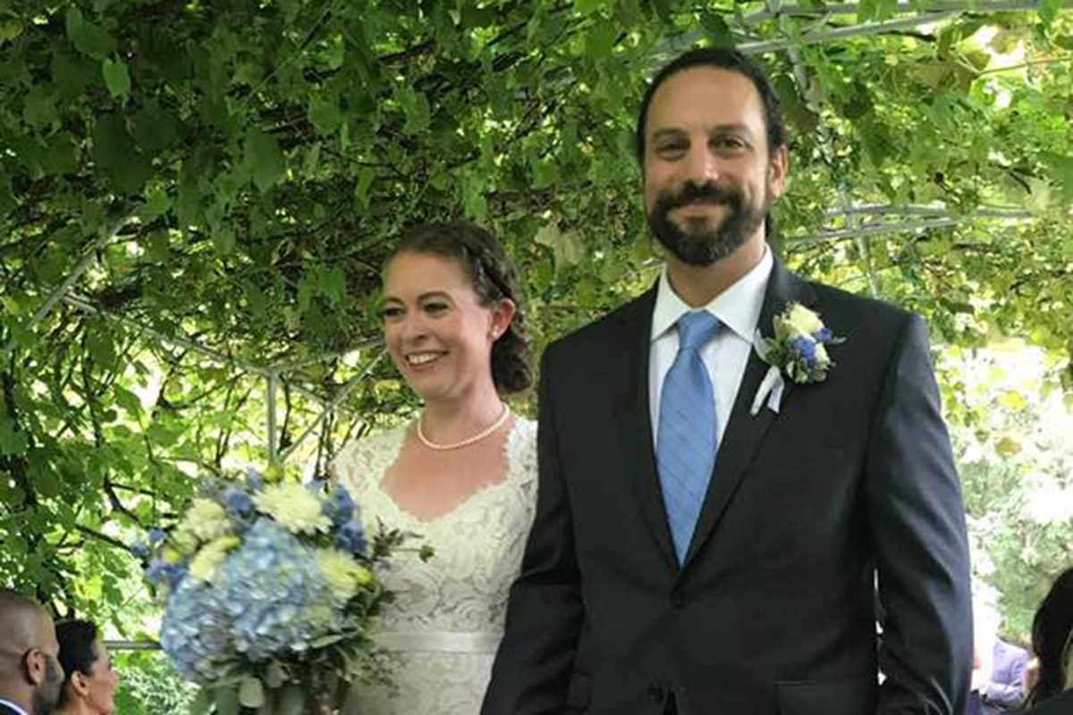 eileen and david walking back down grape arbor after ceremony