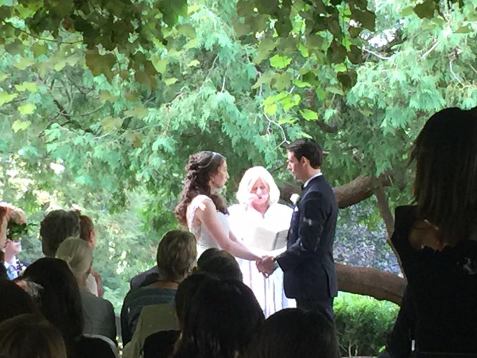 Outdoor Wedding Ceremony couple holding hands in front of the jp under the grape arbor