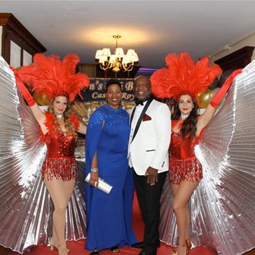 A Las Vegas Style Surprise Party couple-standing-between-dancing-girls